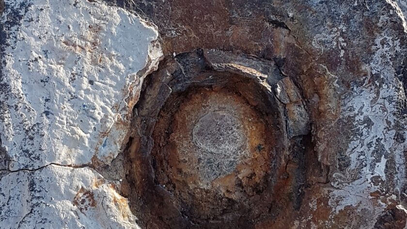 Stahlpfeiler, verrostet mit markanter runder Einkerbung und Farbresten. Fotodruck auf Dibond in diversen Formaten